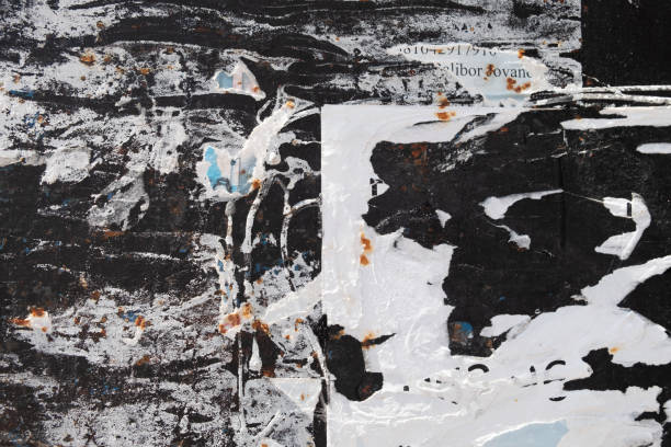 istock Torn and abstract street poster background on a black wall 1415151576