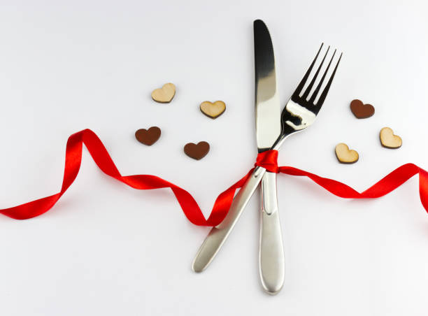 istock Fork and knife decorated red ribbon with bow 1415153317