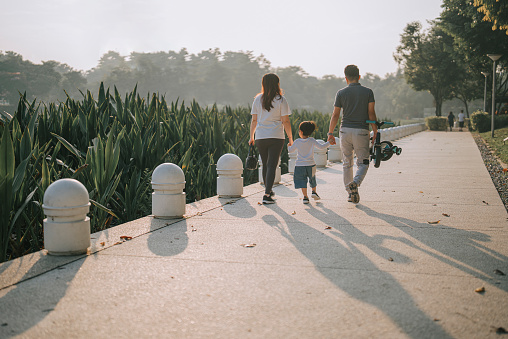 asian chinese family bonding time at public park during weekend leisure time in the morning