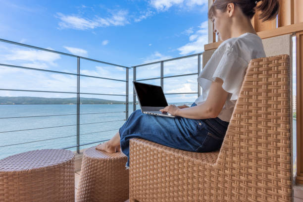 istock Asian woman working while traveling 1415154869