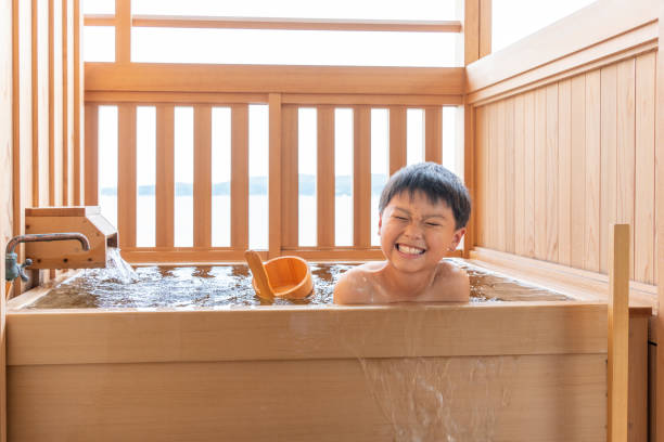 istock Asian boy taking an open-air bath in the guest room 1415155048