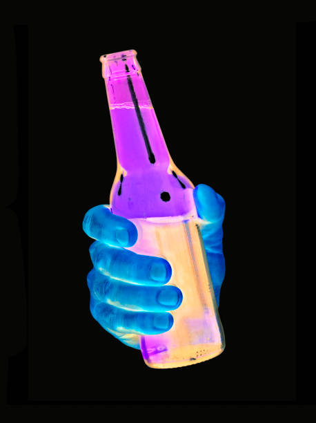 blue hand hold a colorful bottle on black background.