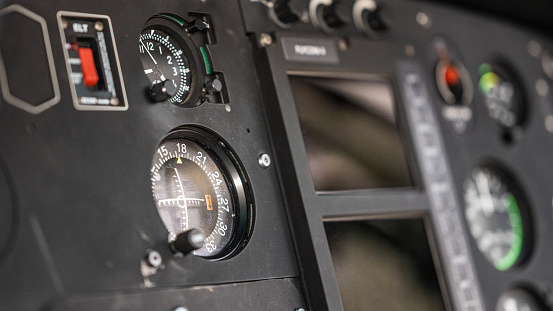 Helicopter control panel, close up on speedometer. Inside of air vehicle cockpit, close view on navigational dashboard and buttons