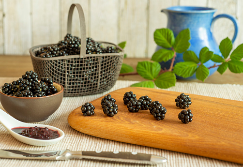 Blackberries in basket with blackberry jam or jelly