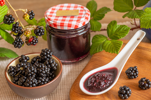 Blackberries in basket with blackberry jam or jelly