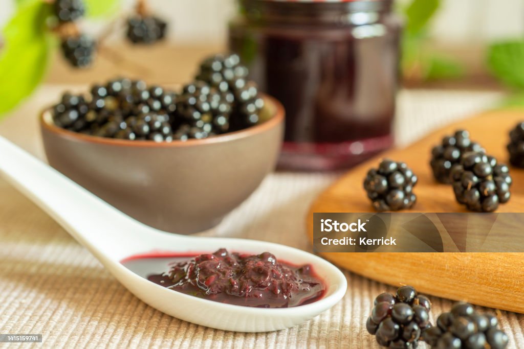 Blackberries in basket with blackberry jam or jelly Canning Stock Photo