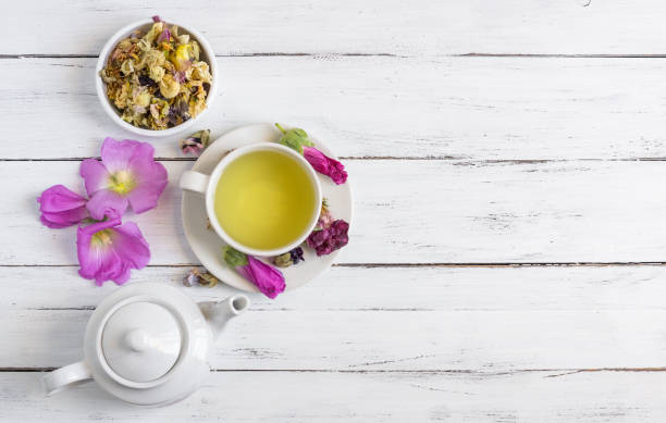 istock Cup of hollyhock tea with dried and fresh hollyhock blossom on rustic table 1415160501