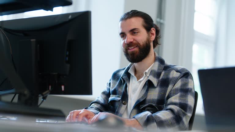 Computer programmer working at his desk in office