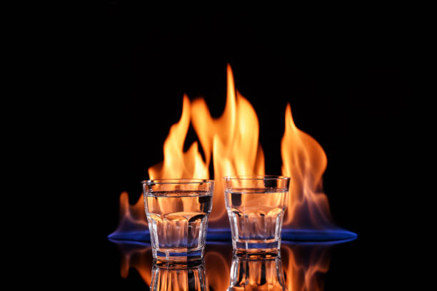 istock Vodka in glasses and flame on black background 1415161911