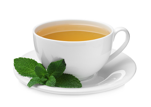 Cup of aromatic green tea with fresh mint on white background