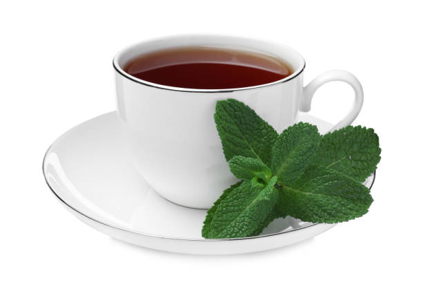 istock Cup of aromatic black tea with fresh mint on white background 1415162243
