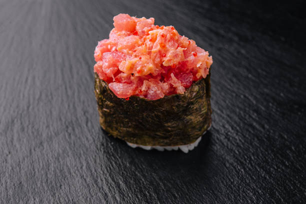 istock Gunkan sushi with tuna and tobiko on black 1415164318