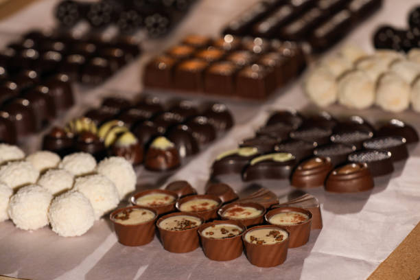 istock Many delicious chocolate candies on table, closeup. Production line 1415165105