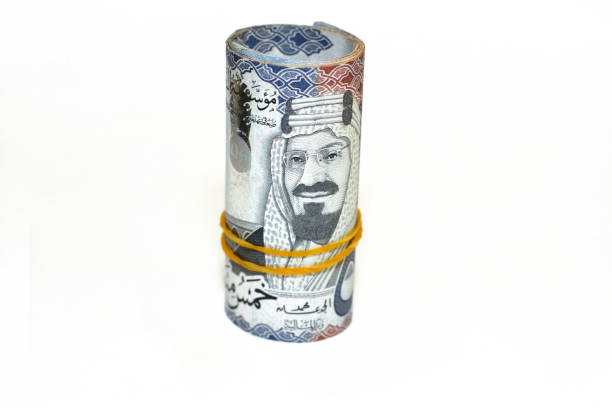 istock 500 Five hundred Saudi Arabia money roll riyals banknotes isolated on white background, Saudi riyals cash money bills rolled up with rubber bands features an image of king AbdulAziz Al Saud 1415165273