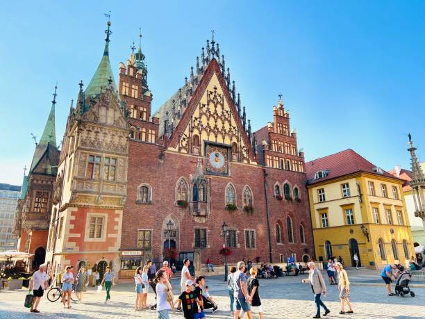 Wroclaw, Poland - August, 8 - 2022:  market square in the historic district at the town hall with tourists and customers.