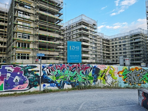 Berlin, Germany – July 08, 2019: A subway station in Berlin, Germany with the wall beside the rails covered in graffiti spray paint