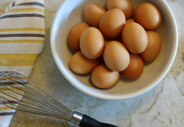 istock Closeup of a dozen brown eggs in a bowl 1415166458
