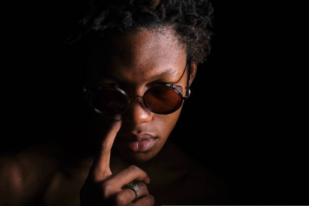 young afro american man in sunglasses on black background copy space. High quality photo