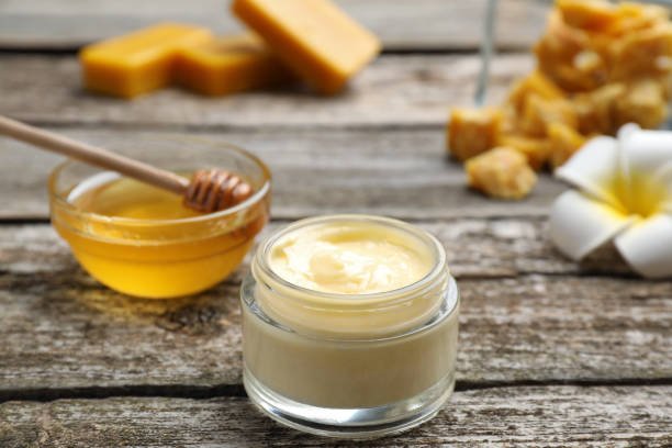 istock Cream with natural beeswax component on wooden table, closeup 1415167225
