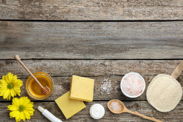 istock Flat lay composition with beeswax and cosmetic products on wooden table. Space for text 1415167287