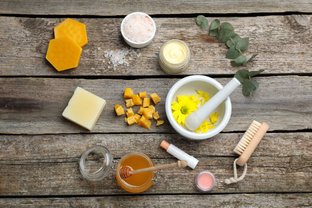 istock Flat lay composition with beeswax and cosmetic products on wooden table 1415167447