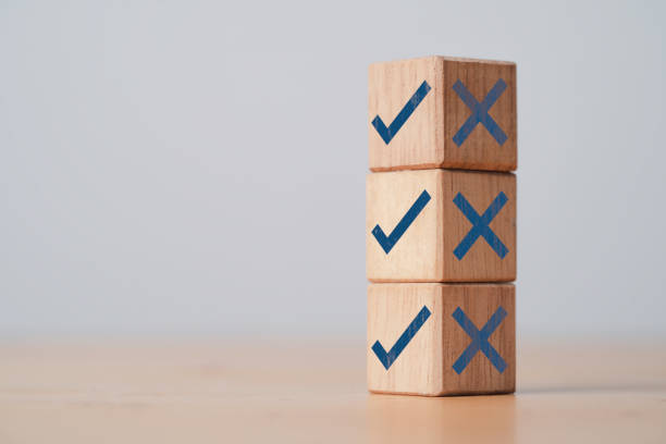 istock Correct sign in bright side and incorrect sign in dark side which print screen on stacking of wooden cube block for approve and reject concept. 1415168024