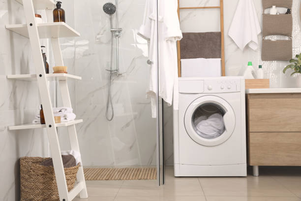 istock Stylish bathroom interior with modern washing machine 1415168133