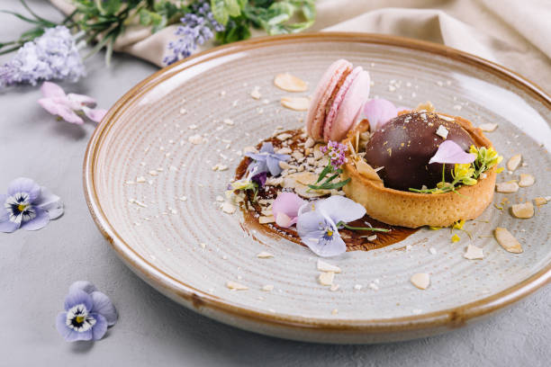 istock chocolate tarts with pink french macarons 1415171388