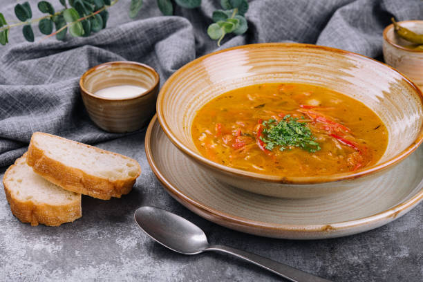 istock Traditional chicken noodle soup in a brown bowl 1415171754