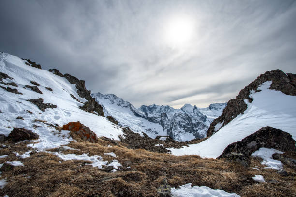 istock Snowcapped mountains under the moody sky 1415171878