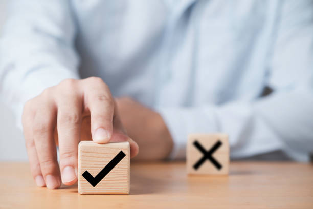istock Hand pushing tick correct sign mark in front of cross mark for approve document and project concept. 1415171989