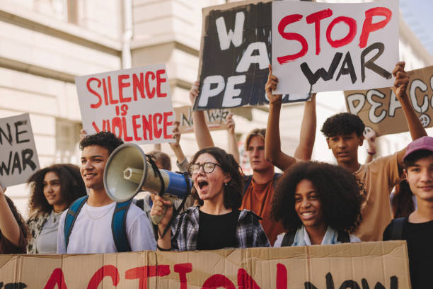 istock Multicultural teenage activists protesting against war and violence 1415172055