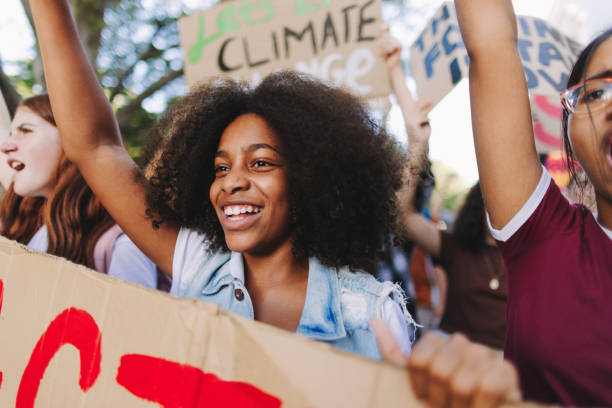 istock Happy young people standing up against climate change and global warming 1415172223