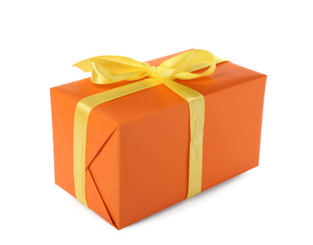 istock Orange gift box with yellow bow isolated on white 1415173041