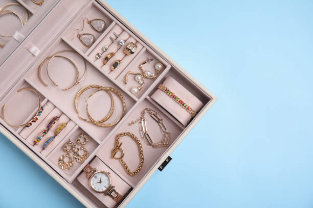 istock Jewelry box with stylish golden bijouterie on light blue background, top view. Space for text 1415173241