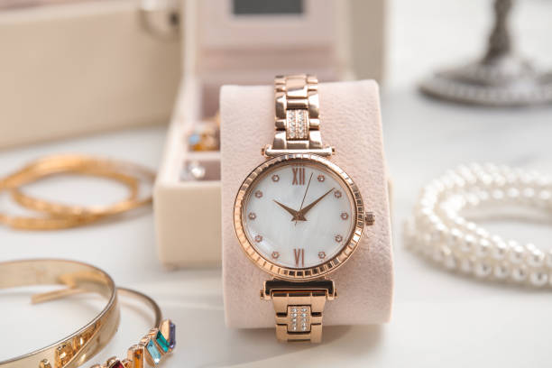 istock Elegant watch and bijouterie on white marble table 1415173409