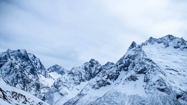 istock Snowcapped mountain ridge under the moody sky 1415173425