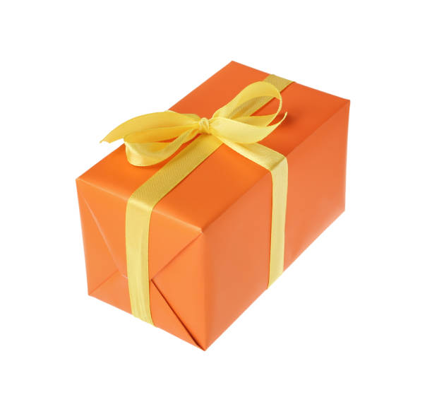istock Orange gift box with yellow bow isolated on white 1415173801