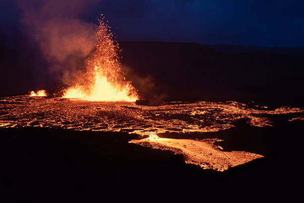 Volcano eruption at Meradalir near Fagradalsfjall, Iceland. Erupting magma and flowing lava at night. stock photo