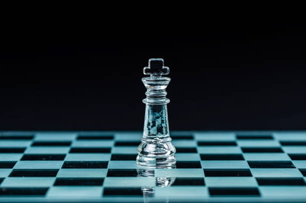 istock glass chess board game in black background ,selective focus on King, leadership concept 1415177593