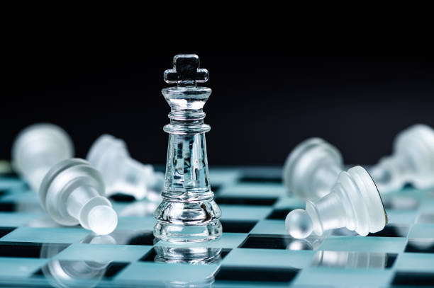 istock glass chess board game in black background ,selective focus on King, leadership concept 1415177752