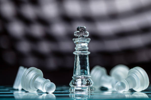 istock glass chess board game in black background ,selective focus on King, leadership concept 1415177777