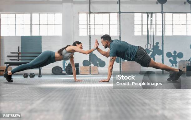 Fitness Partners Exercising Together And Doing Pushups High Five At The Gym Fit And Active Man And Woman Training In A Health Facility As Part Of Their Workout Routine A Couple Doing An Exercise Stock Photo - Download Image Now