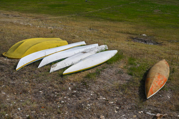Boats and canoes on the shore of the lake