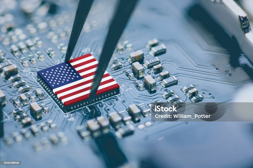Flag of USA on a processor, CPU Central processing Unit or GPU microchip on a motherboard. Congress passes the CHIPS Act of 2022 to strengthen domestic semiconductor manufacturing, research and design. Computer Chip Stock Photo