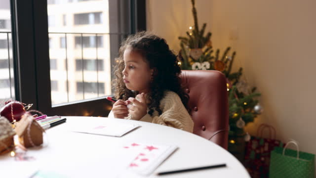Little girl drawing Christmas cards