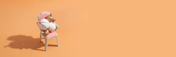 istock Creative autumn banner with still life composition. Gold and white decorative pumpkins on a chair 1415184441
