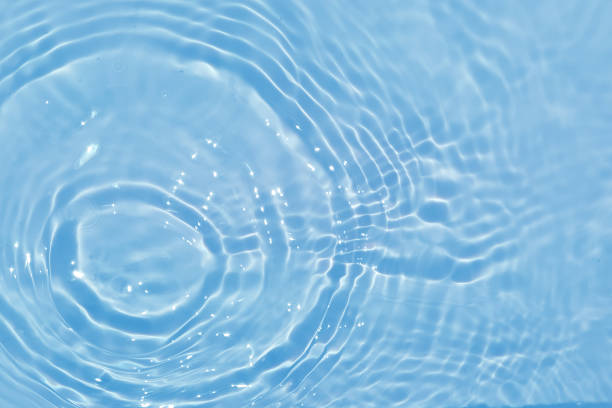 istock Defocus blurred transparent blue colored clear calm water surface texture with splashes and bubble. Trendy abstract nature background. Water wave in sunlight with copy space. Blue watercolor texture 1415184731