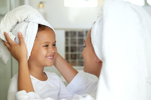 Happy, caring and sweet mother and daughter spa day at home for healthy skincare, hair care and personal hygiene routine. Smiling cute girl and woman bonding and enjoying pamper treatment together