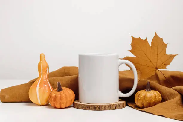 Photo of Mockup mug with autumn maple leaf and